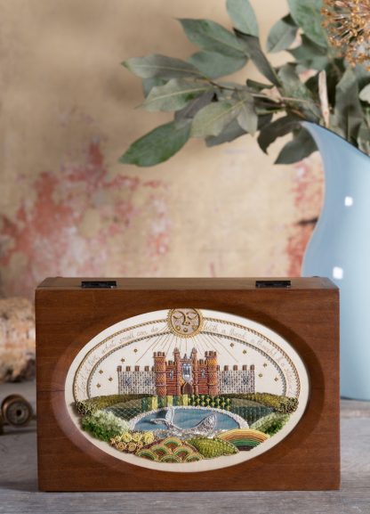 Hampton Court Sampler, in wooden casket with an oval aperture